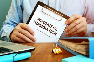 employee holds papers about wrongful termination