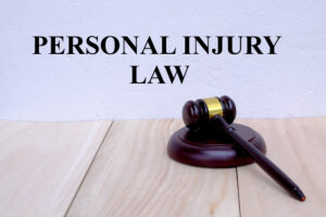 Personal Injury Law written on the wall with gavel on wooden background