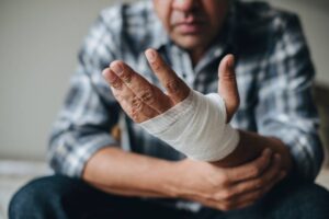 Man with a gauze bandage wrapped around his hand