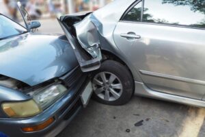 Car crash accident on street with wreck and damaged automobiles. Accident caused by negligence And lack of ability to drive. Due to illness