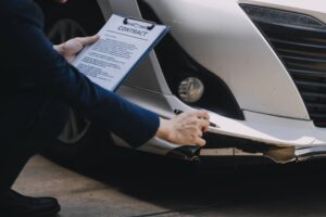 A young businesswoman is navigating car insurance options at her desk, considering premiums, deductibles