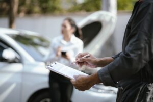 Asian woman calls insurance company for help after car accident