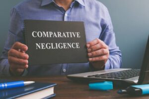 Man shows Comparative negligence data in the book.